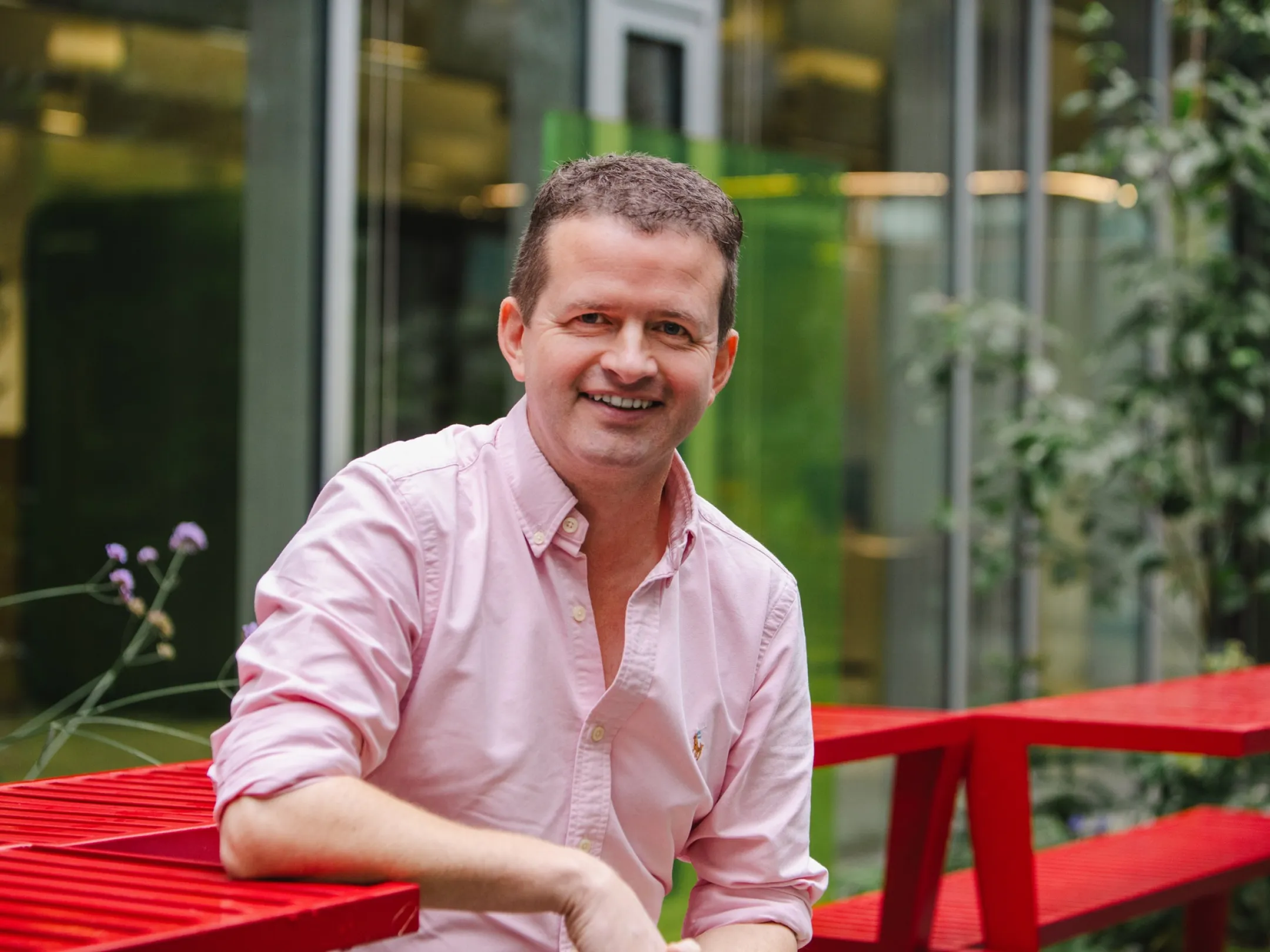 Calvin sitting on a red bench